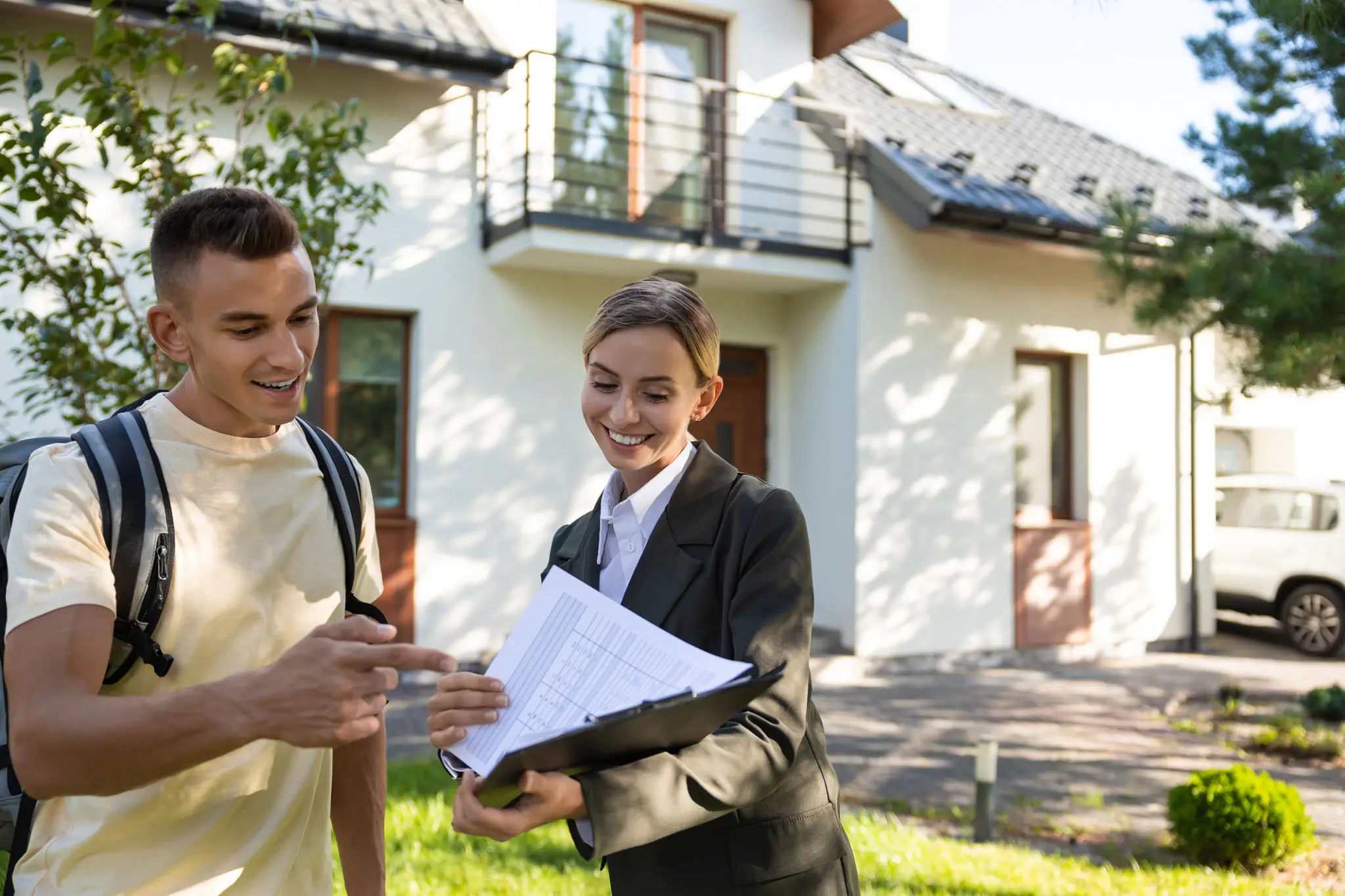Real estate agent showing a house to a client with documents.